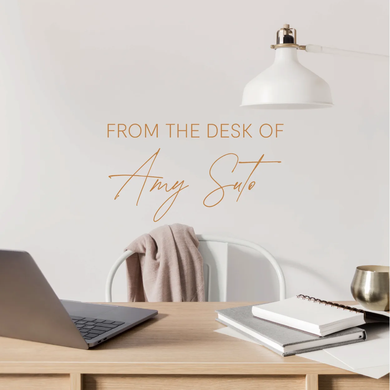 A writing desk with a laptop, notebooks, and a lamp under the words From the Desk of Amy Suto