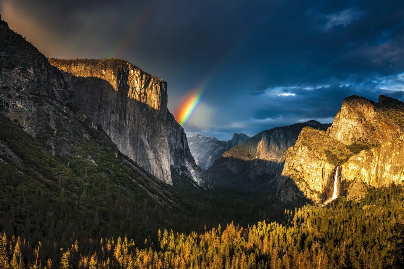 Yosemite Valley at golden hour with a rainbow over the cliffs, the Hard Hike chapter image from the official 12 Scrappy Founders Season One site