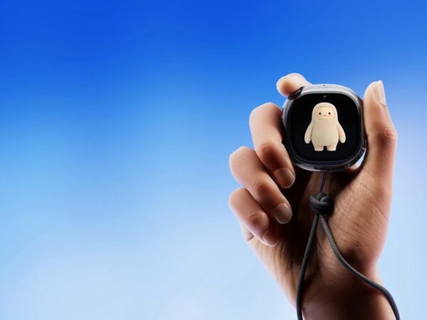 Hand holding the Meta Muse Charm device showing the Muse avatar on its screen