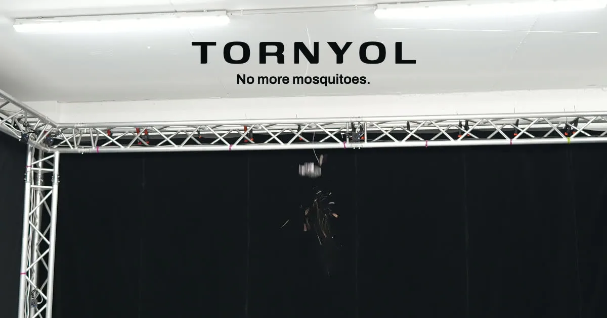 The Tornyol mosquito hunting micro drone in flight inside a black test rig, under the Tornyol wordmark and its No more mosquitoes line